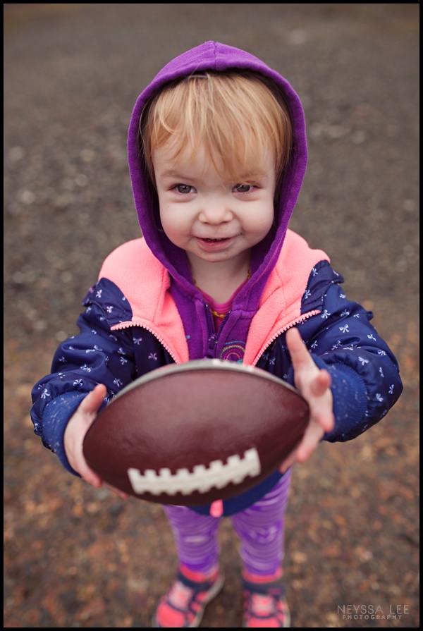 Toddler girl with football