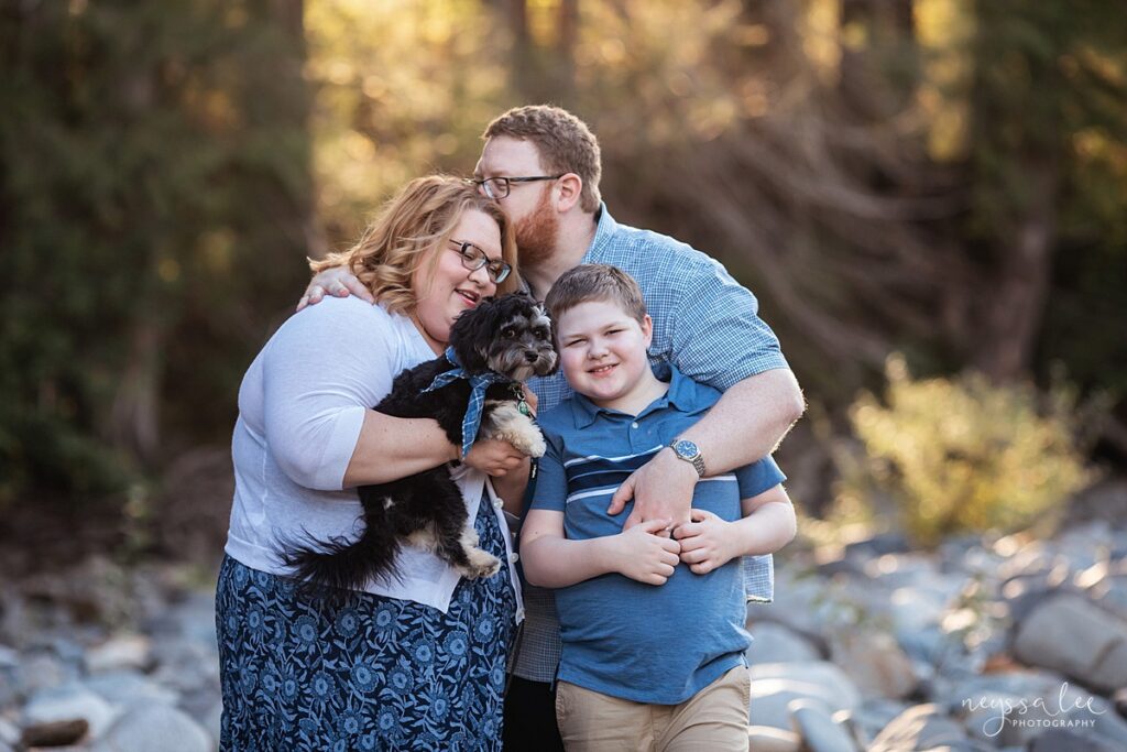Family with a dog and boy for family portraits at Tanner Landing Park