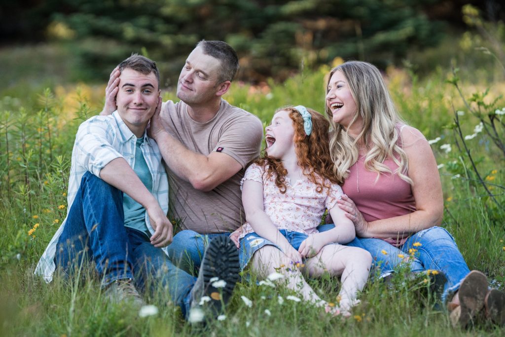 Family in the grass at Gold Creek Pond