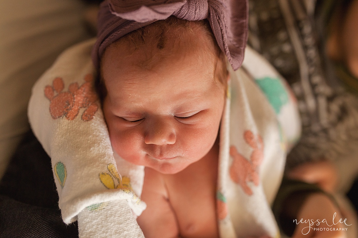 Newborn baby girl with purple headband