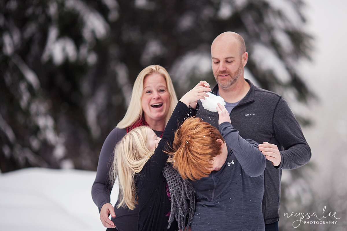Family photos in the snow leads to a snowball fight being captured