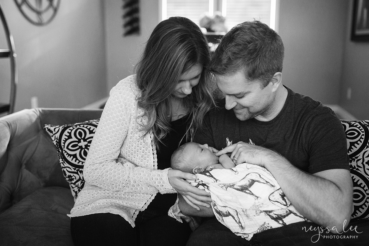 Family in living room during newborn baby boy photography session 