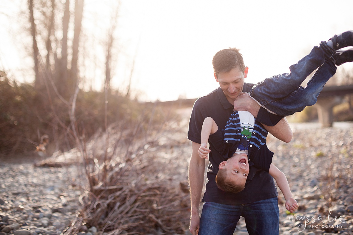 Family Photos by the River at Sunset, Neyssa Lee Photography, Snoqualmie Family Photography, Dad hangs son upside down