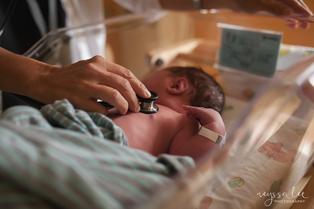 Doctors hands on newborn baby
