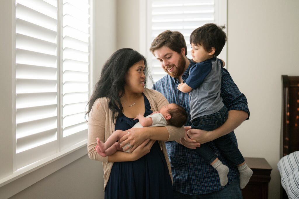 Family of four during lifestyle baby portraits in Seattle area