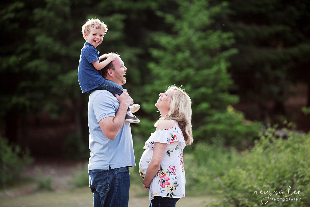 Family laughing during maternity photos in the mountains of Snoqualmie Pass