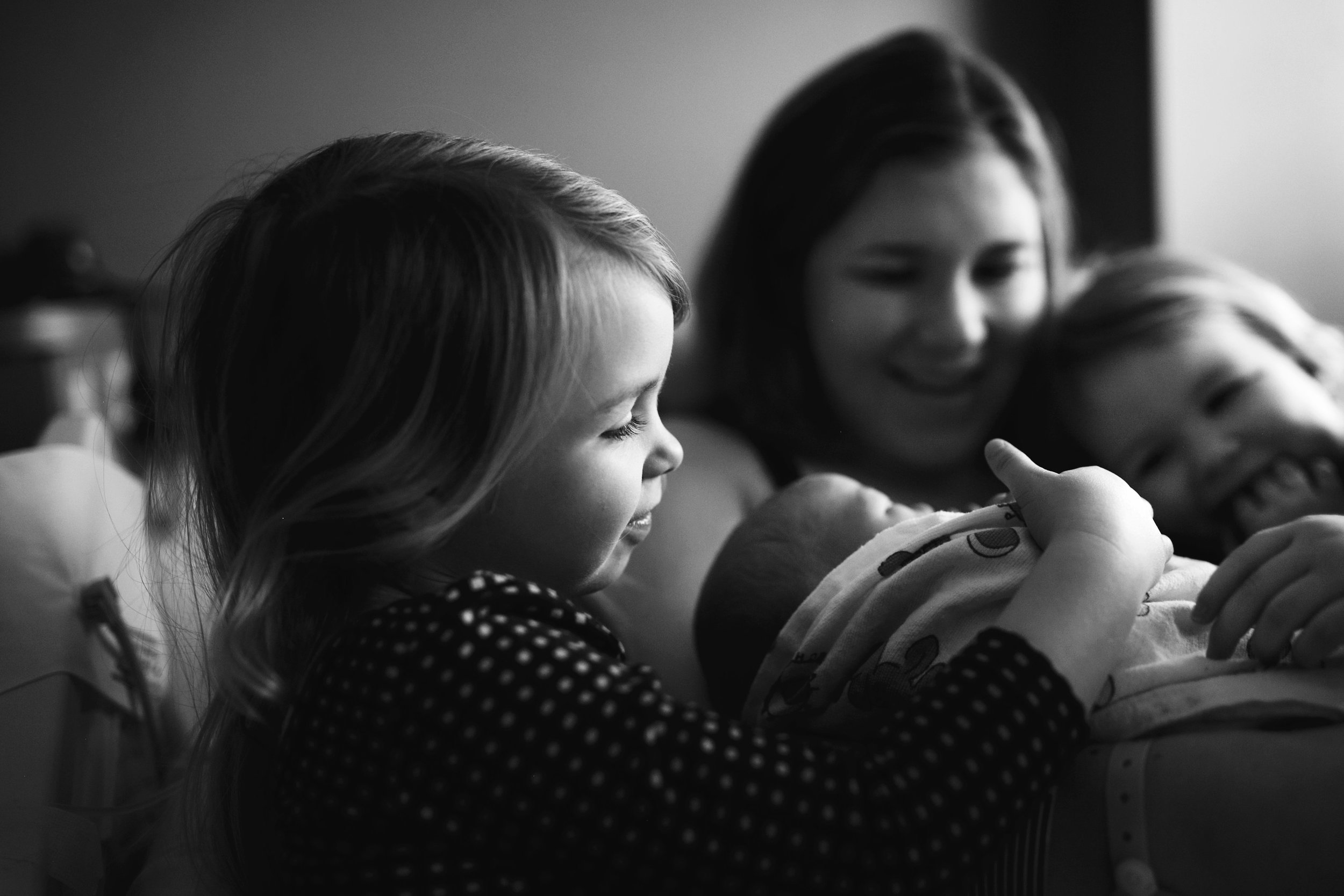 Photo by Megann Robinson - My girls meeting their baby brother for the first time.