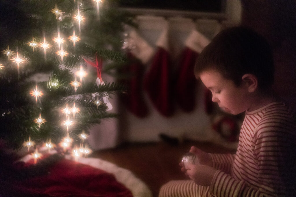 Artistic photo of boy by the Christmas tree