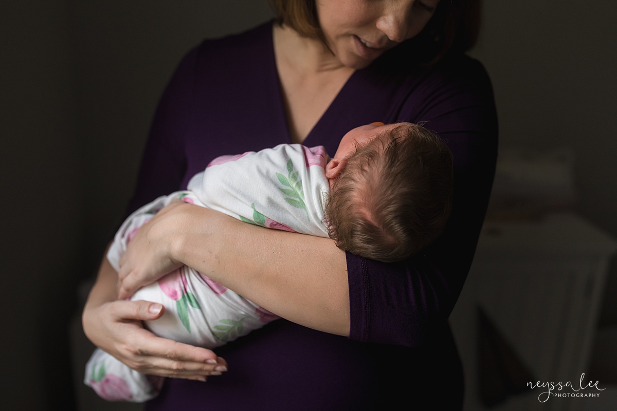 Seattle newborn photographer, Neyssa Lee Photography, Lifestyle Newborn Photography, photo of swaddled newborn baby girl in moms arms