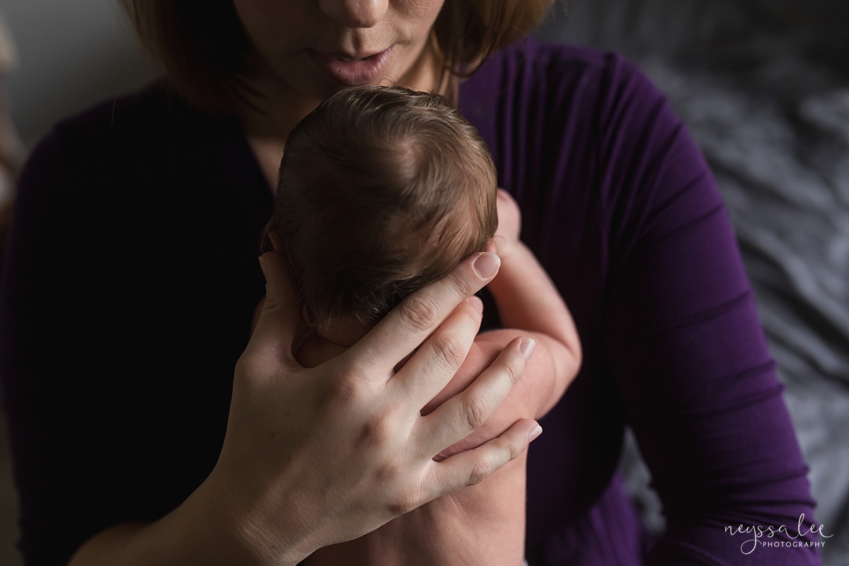 Seattle newborn photographer, Neyssa Lee Photography, Lifestyle Newborn Photography, photo of mom holding newborn baby up close to her face