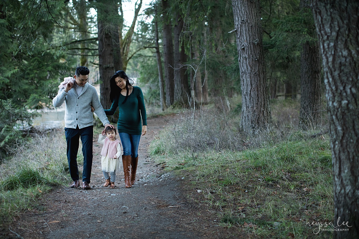 Neyssa Lee Photography, Seattle Lifestyle Family Photographer, Photo of Mom and dad walking along a wooded trail with daughter