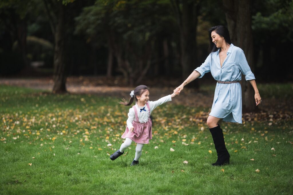 Girl dancing and playing with mother during family photos in Snoqualmie, WA