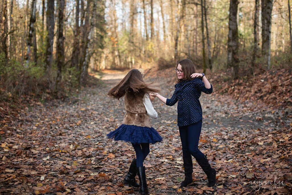 Sisters twirling during fall family photos in Carnation, Wa