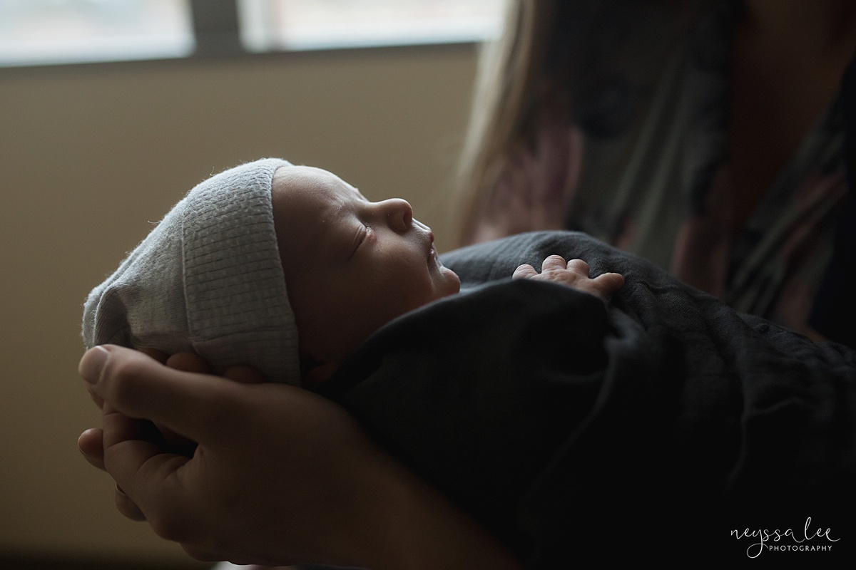 Profile photo of swaddled newborn by Seattle newborn photographer