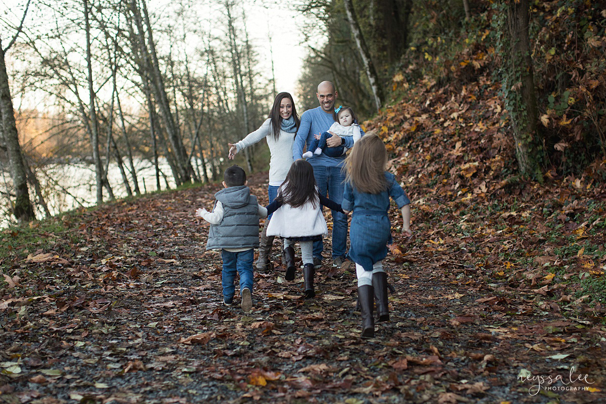 Lifestyle photo of kids running towards mom and dad's open arms at Snoqualmie park