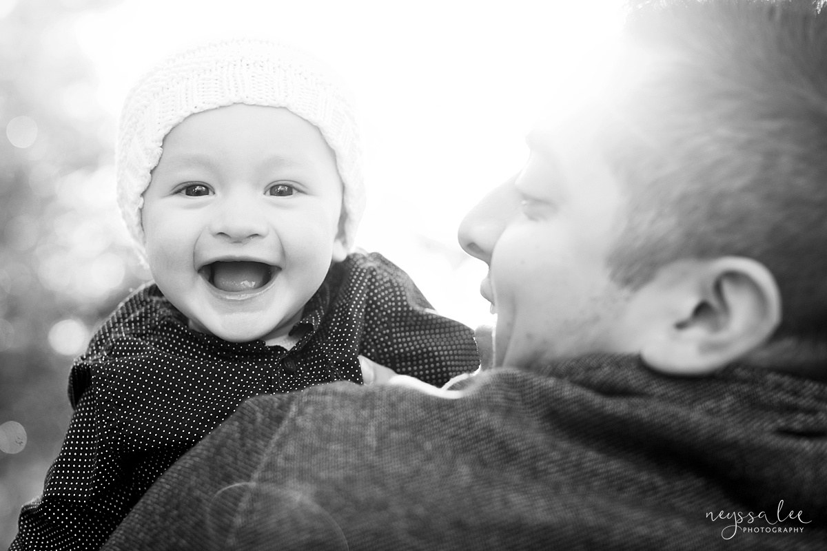 Uncooperative Kids During Family Photos, Neyssa Lee Photography, Seattle Family Photographer, Issaquah Photography, Black and white photo of baby smiling as dad plays with him