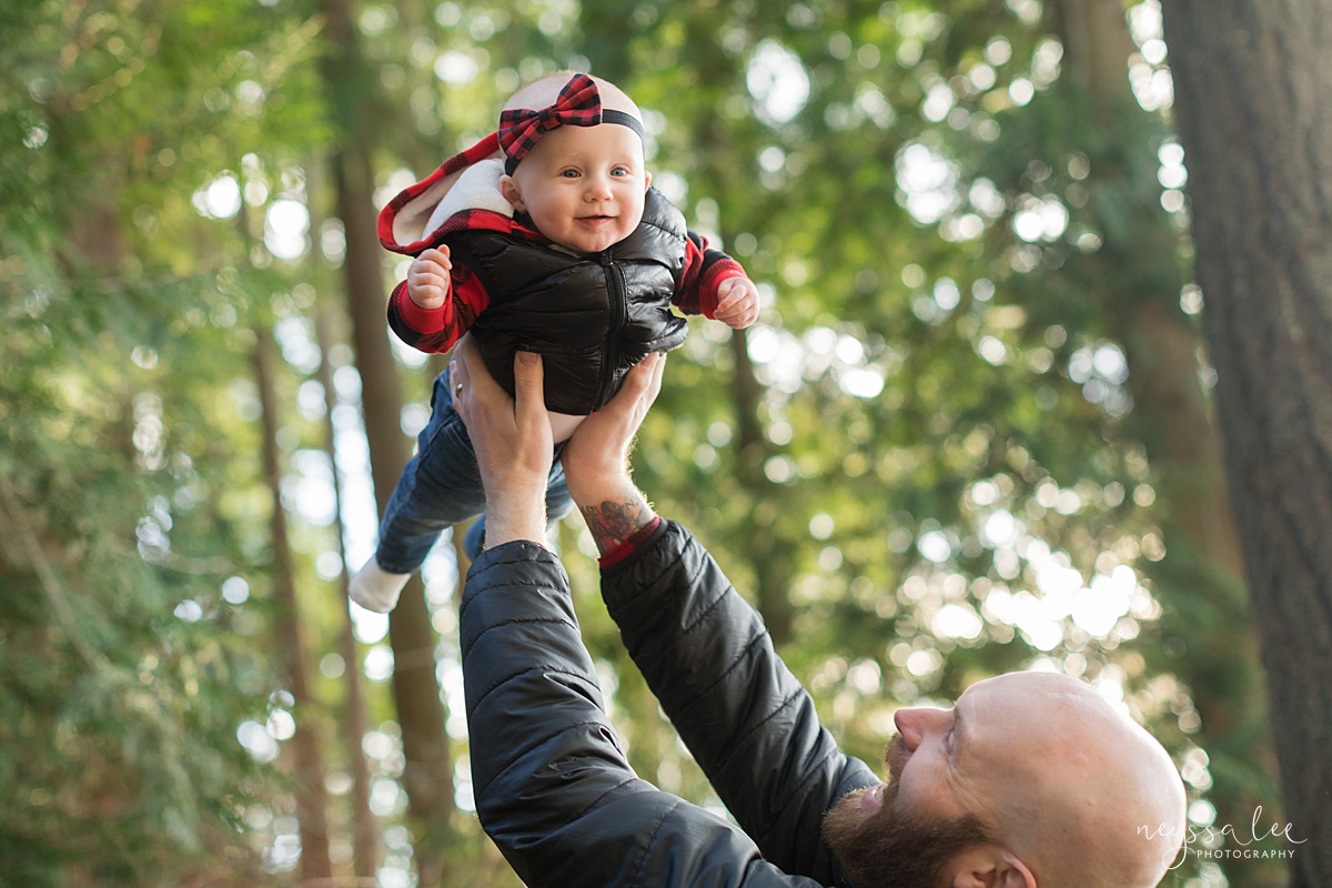 Best Age to Photograph Baby, Neyssa Lee Photography, Seattle Baby Photographer, Photo of dad lifting baby girl into the air