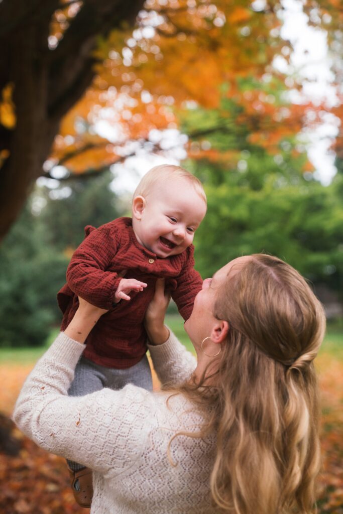 Baby girl with mom playful during Seattle fall family photo session