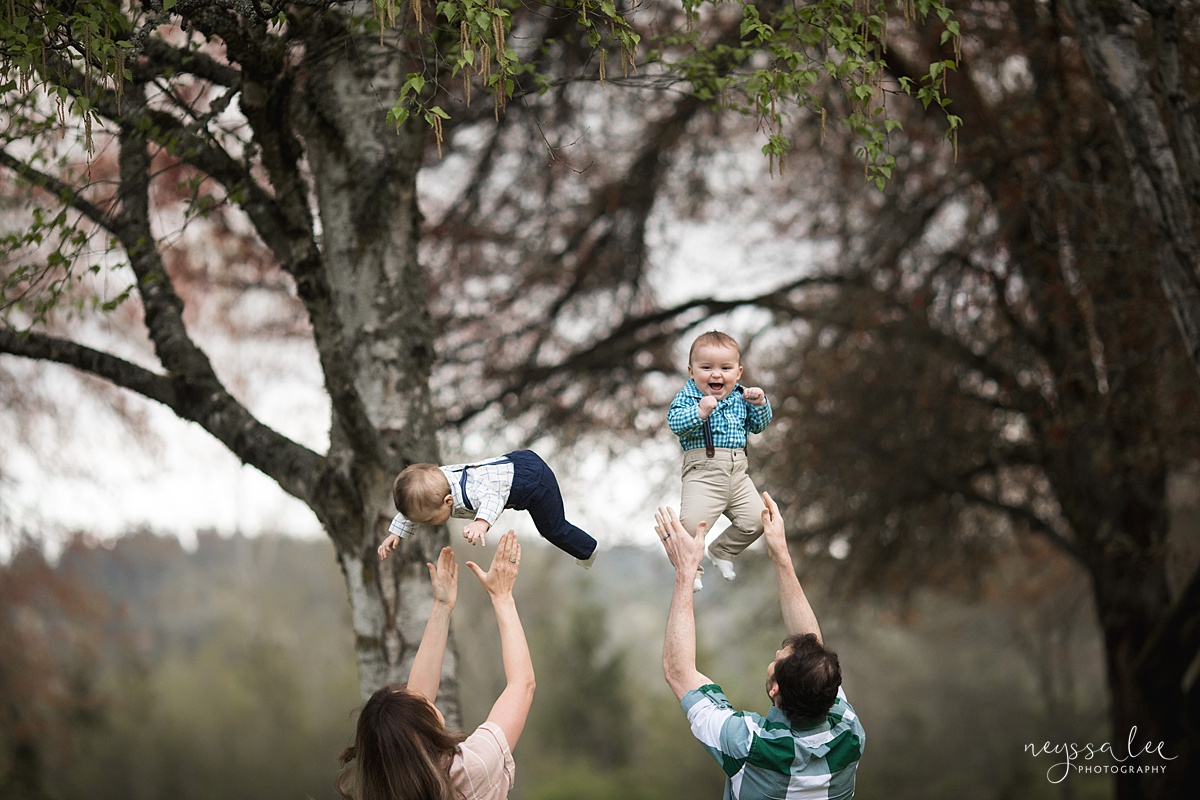 Neyssa Lee Photography, Issaquah Family Photographer, Family Photos with Grey Skies, Lake Sammamish State Park, Photo of parents playfully tossing twin boys into air