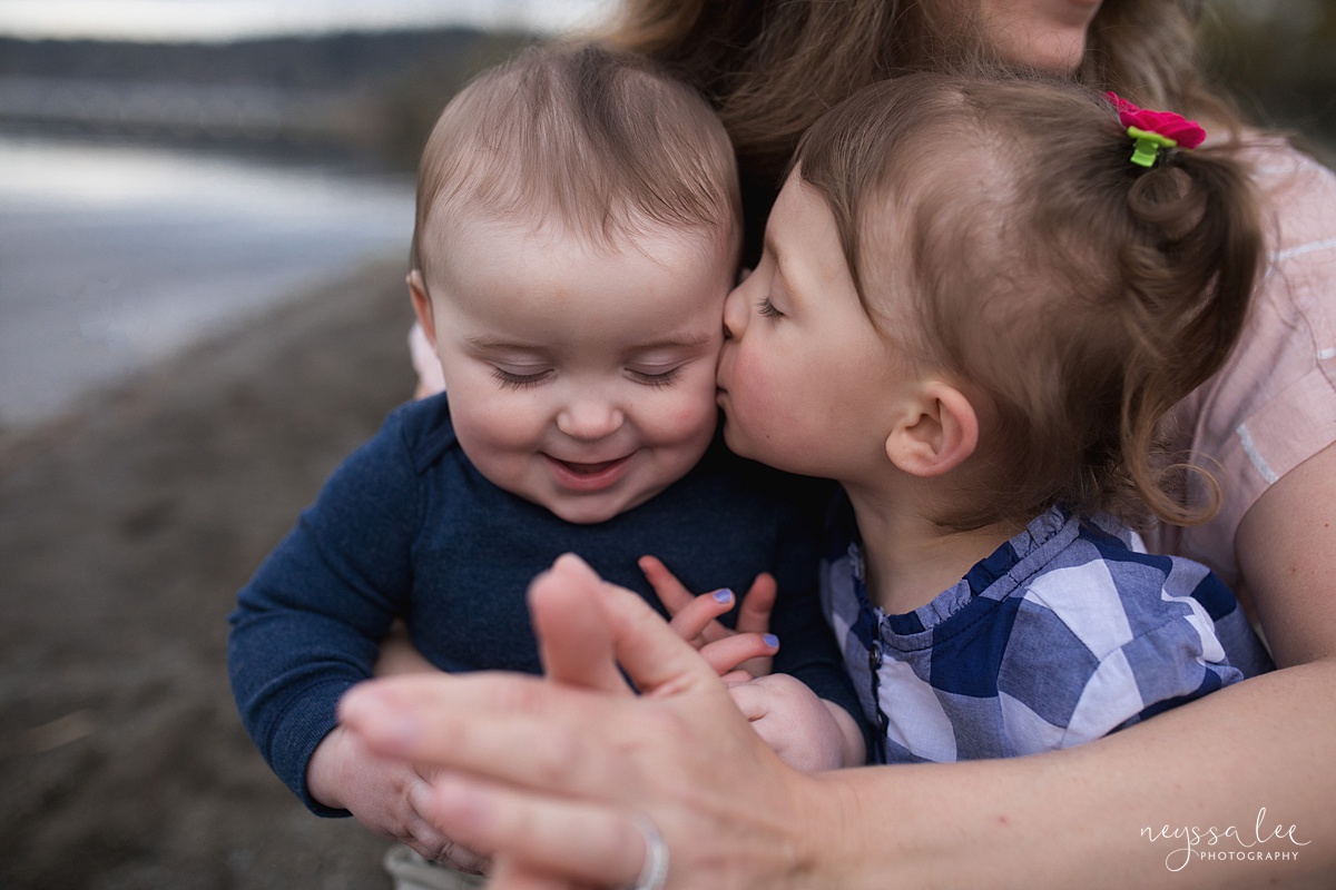 Neyssa Lee Photography, Issaquah Family Photographer, Family Photos with Grey Skies, Lake Sammamish State Park, Photo of big sister kissing baby brother