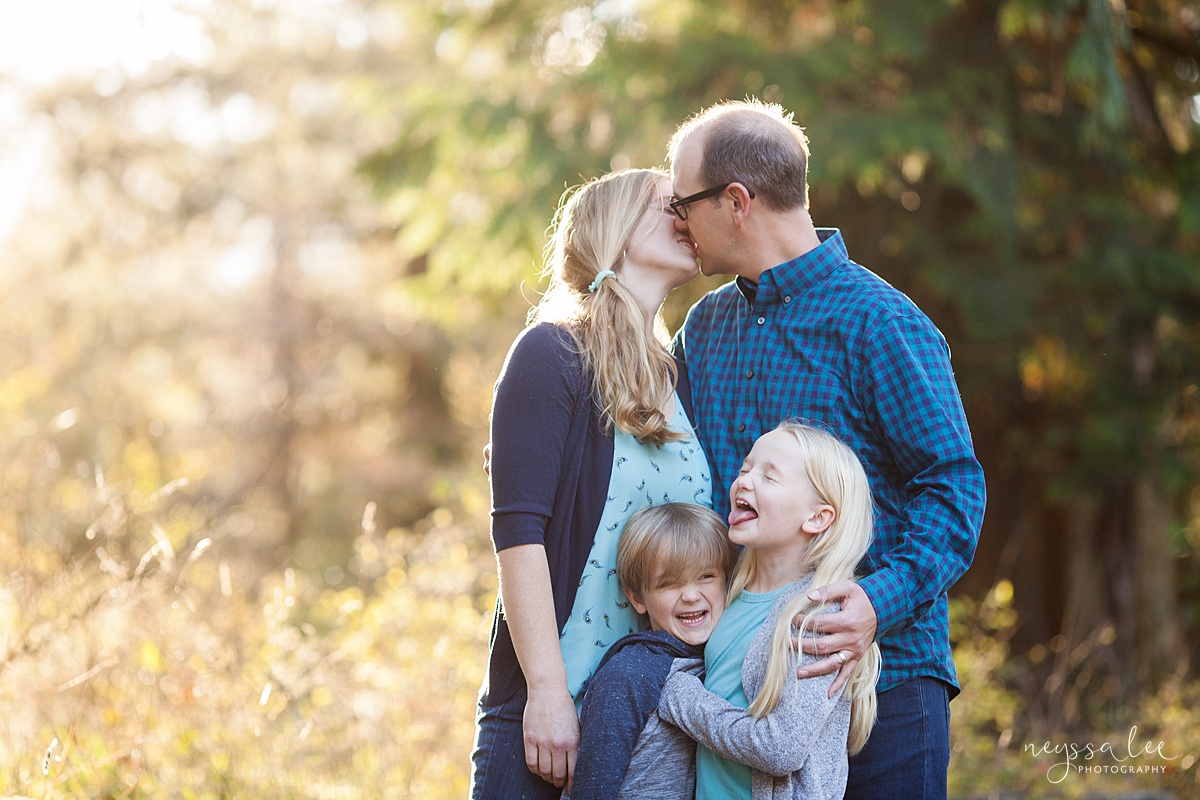 Neyssa Lee Photography, Seattle Family Photo Experience, Photo of mom and dad kissing and girl making face