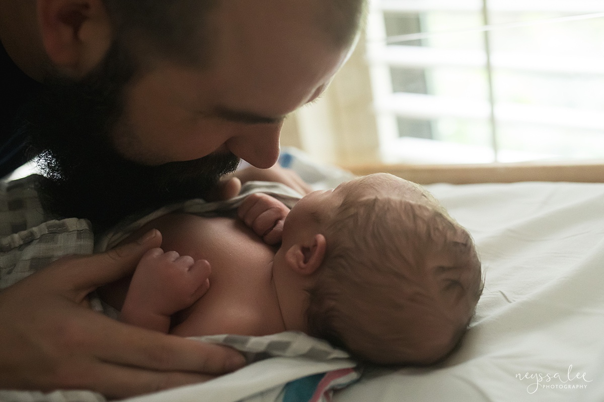 Neyssa Lee Photography, Issaquah Fresh 48 Photographer, Issaquah Newborn Photographer, Photo of dad kissing newborn baby in hospital bassinet