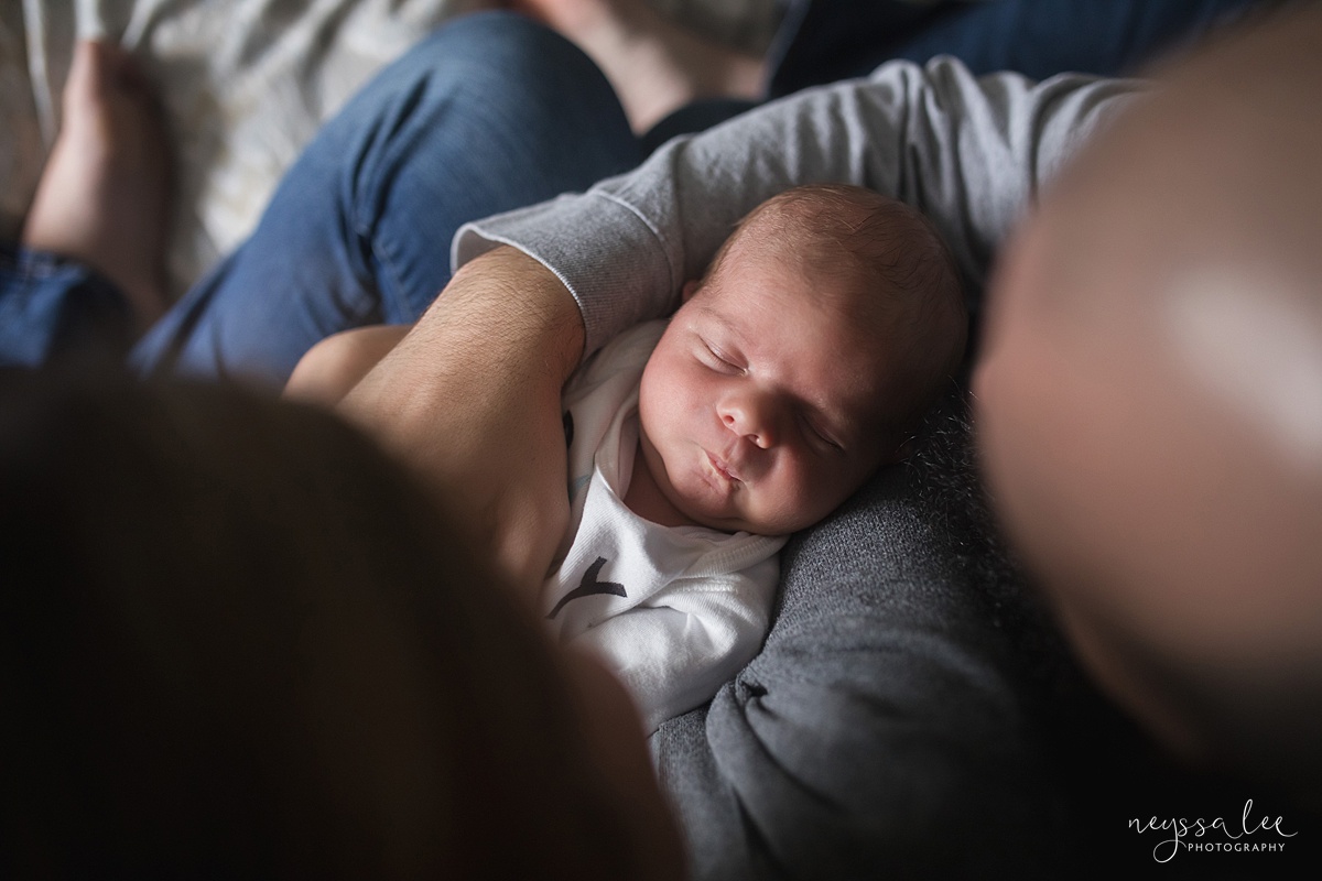Photo of Newborn baby boy from above in dad's arms