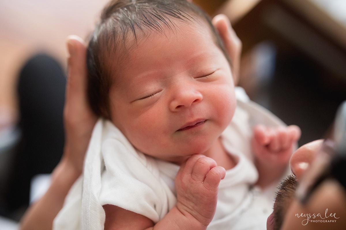 Neyssa Lee Photography, Seattle Newborn Photographer, Bellevue Lifestyle Newborn Photographer,  Photo of newborn baby girl's face in dad's hands