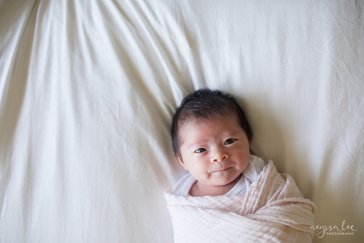 Neyssa Lee Photography, Seattle Newborn Photographer, Bellevue Lifestyle Newborn Photographer,  Photo of swaddled newborn baby looking at camera
