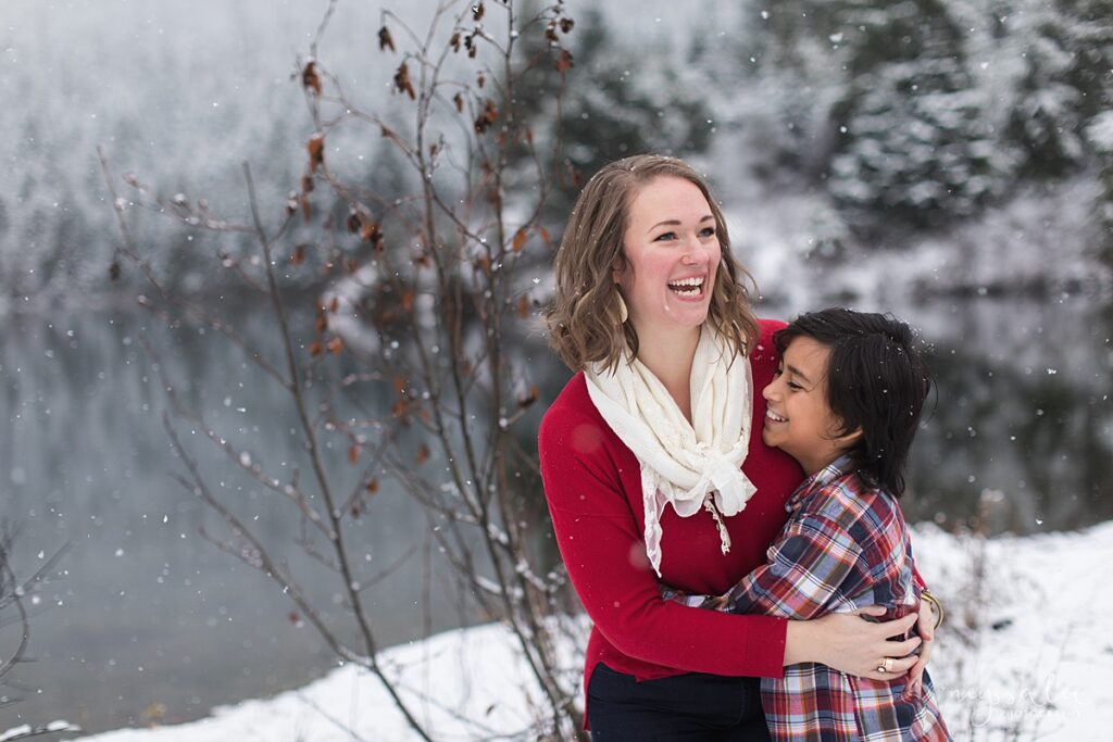 mother and son hugging for family photos in the snow