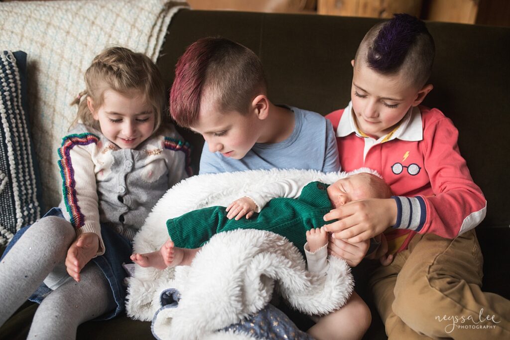 Three Siblings holding newborn baby brother during Snoqualmie Valley newborn photo session
