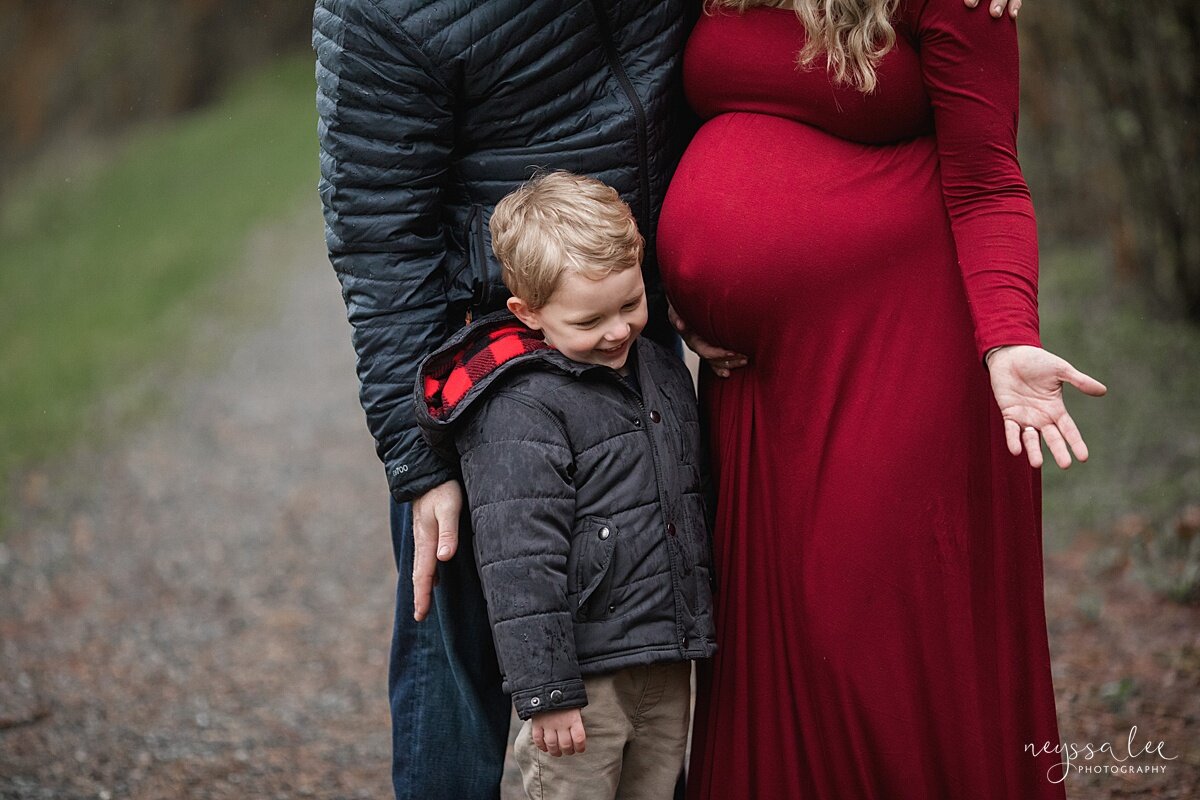 Beautiful Maternity Photos in the Rain, Neyssa Lee Photography, Issaquah maternity photographer,  Close up photo with boy laughing and feeling for baby kicks