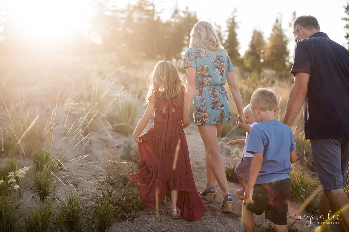 Benefits of family photos on vacation, Neyssa Lee Photography, Chelan Family Photographer, Photo of family walking together in a field