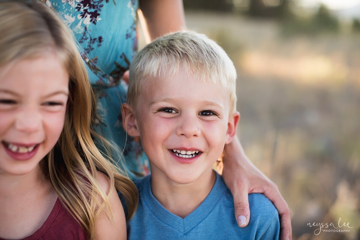 Benefits of family photos on vacation, Neyssa Lee Photography, Chelan Family Photographer,  Portrait of a smiling boy with his mom and sister nearby