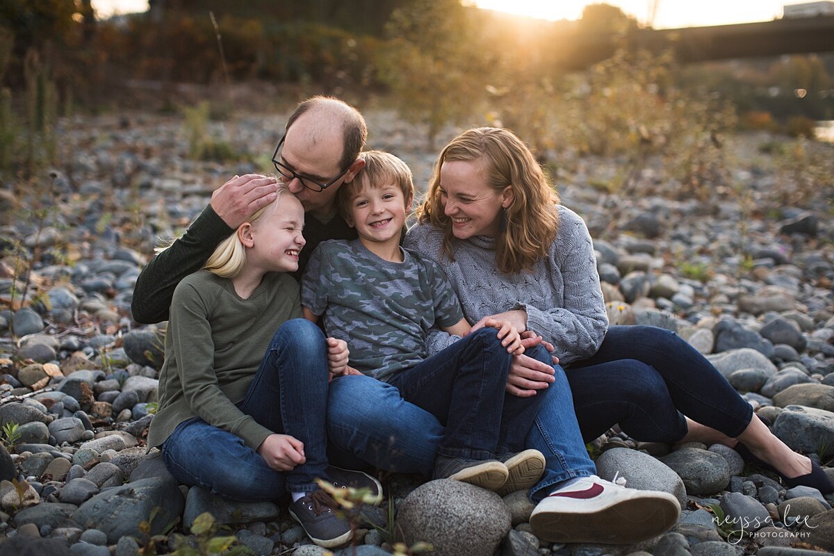What Happens During a Lifestyle Family Photo Session, Neyssa Lee Photography, Issaquah Family Photographer, Photo of family sitting together on river rocks