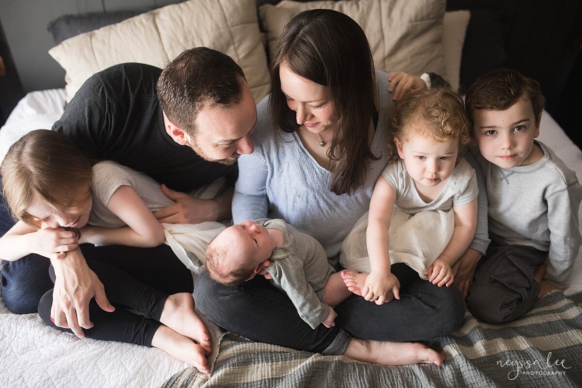 Lifestyle newborn photo of family of six