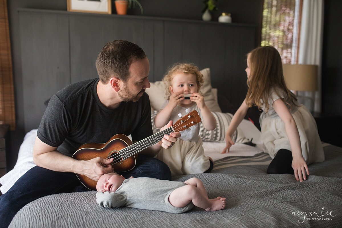 Newborn photo of family playing instruments during Seattle newborn photo session