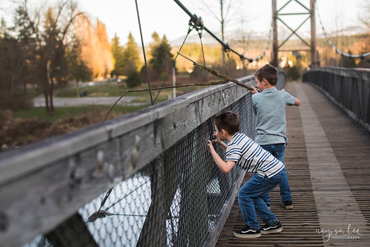 Family Photo Session with Social Distancing, Neyssa Lee Photography, Seattle Family Photographer, Lifestyle family photo of brother throwing sticks into the river