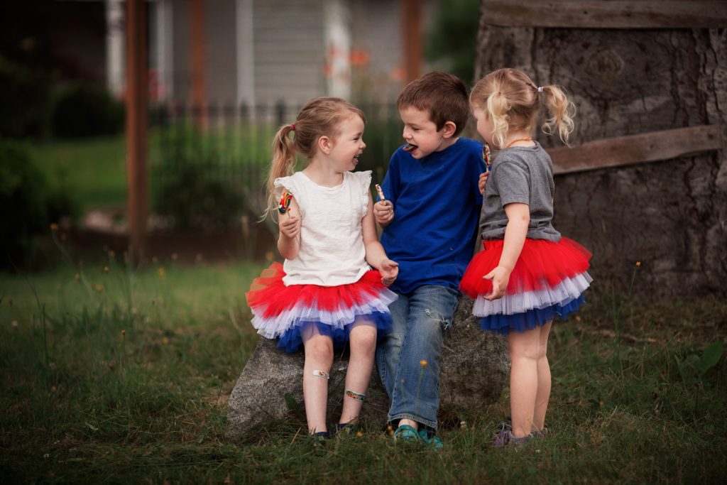 kids eating lollipops in 4th of July photo