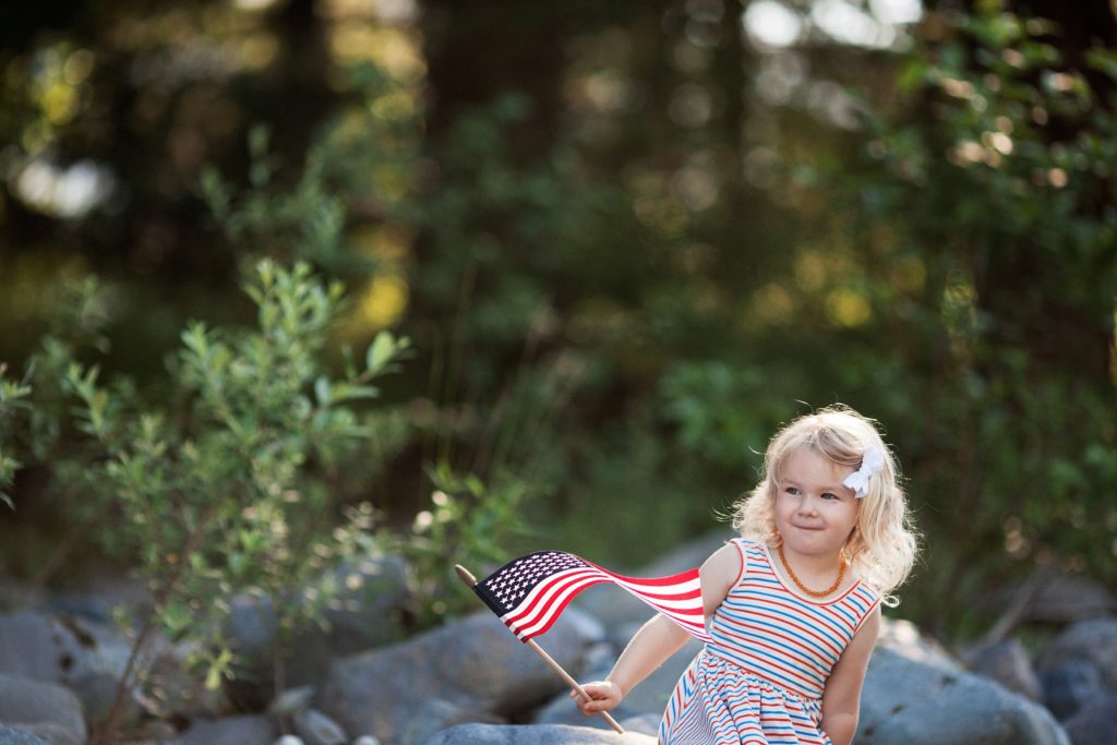 preschool girl waving American flag