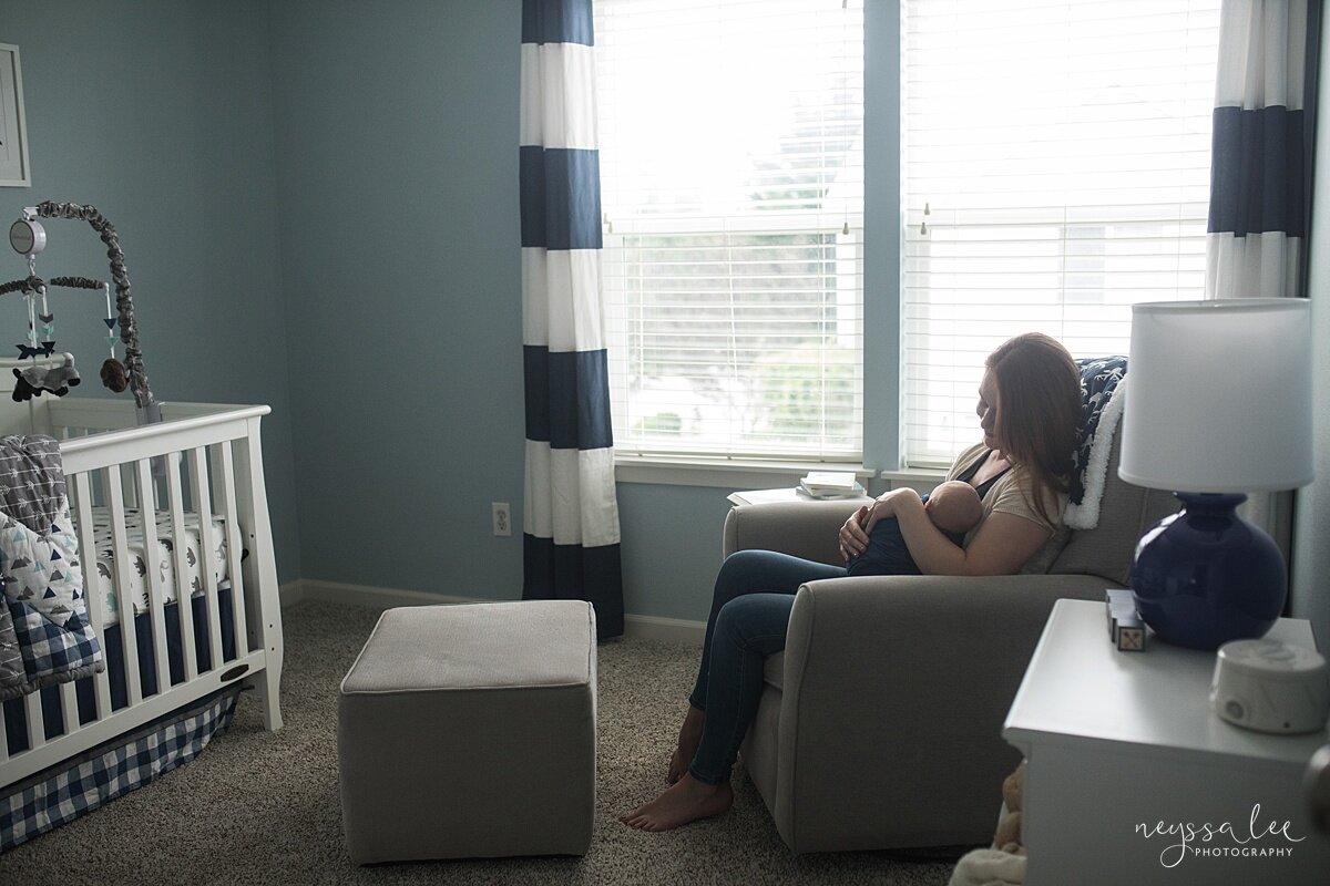 Wide angle photo of mom sitting in nursery with baby by Snoqualmie photographer