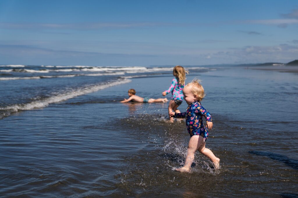 Toddler running into the ocean at Ocean Shores beach