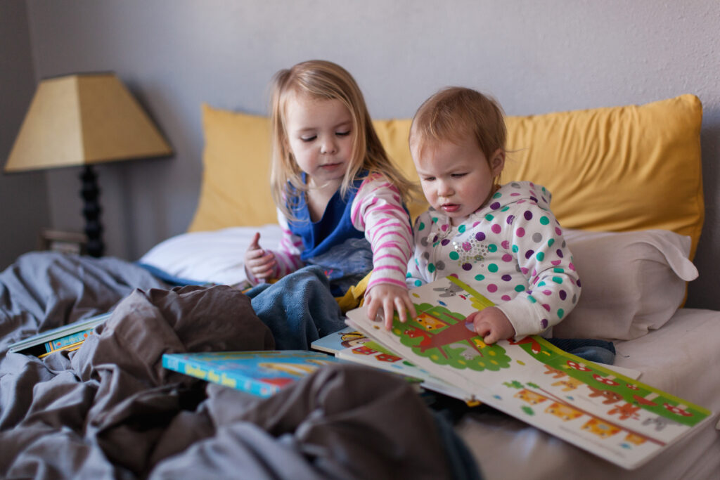 siblings reading toddler books together