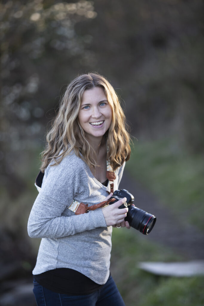 Seattle newborn photographer wearing a Fotostrap camera strap
