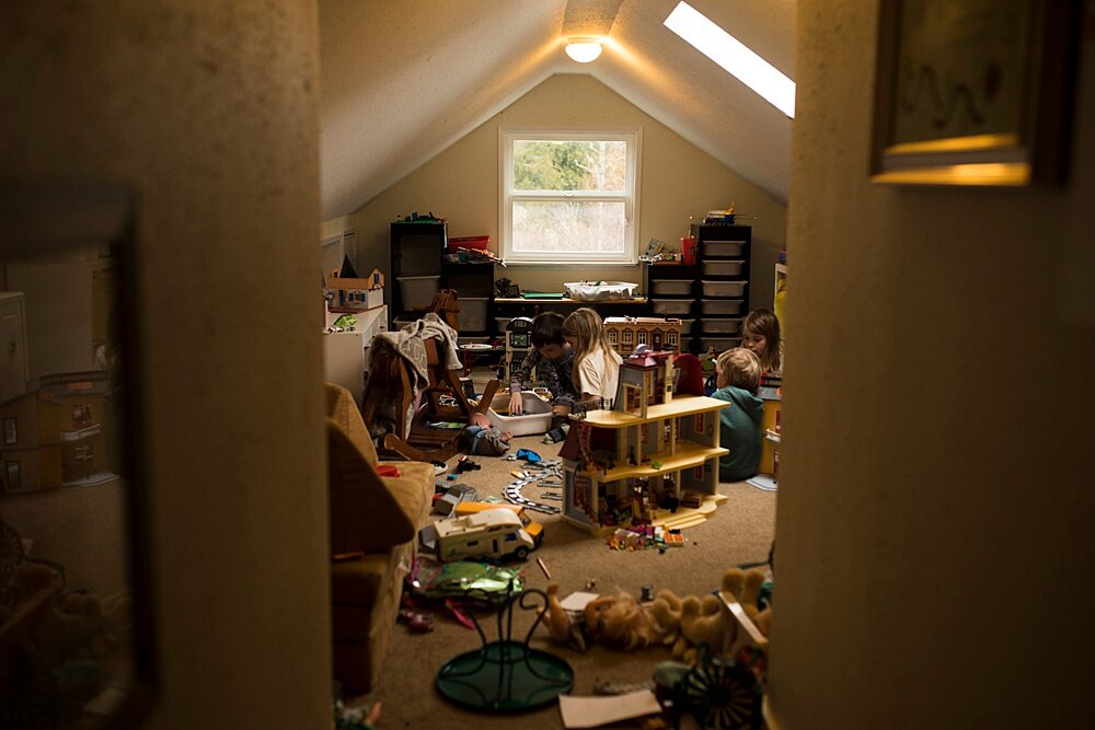 indoor photography tip pullback as example of space using for the rest of this article. Messy playroom with kids playing