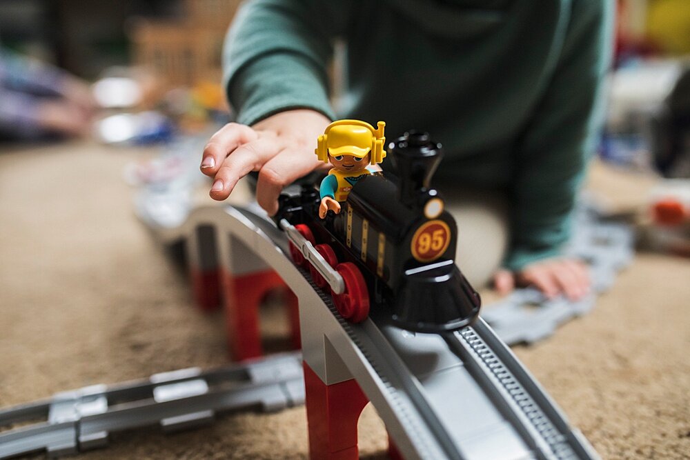 closeup of photo of child playing with lego duplo train