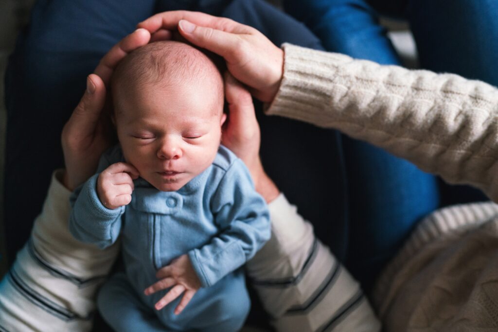 Best time of day for newborn portraits in Seattle, in-home newborn photo session, sleeping baby in parents arms
