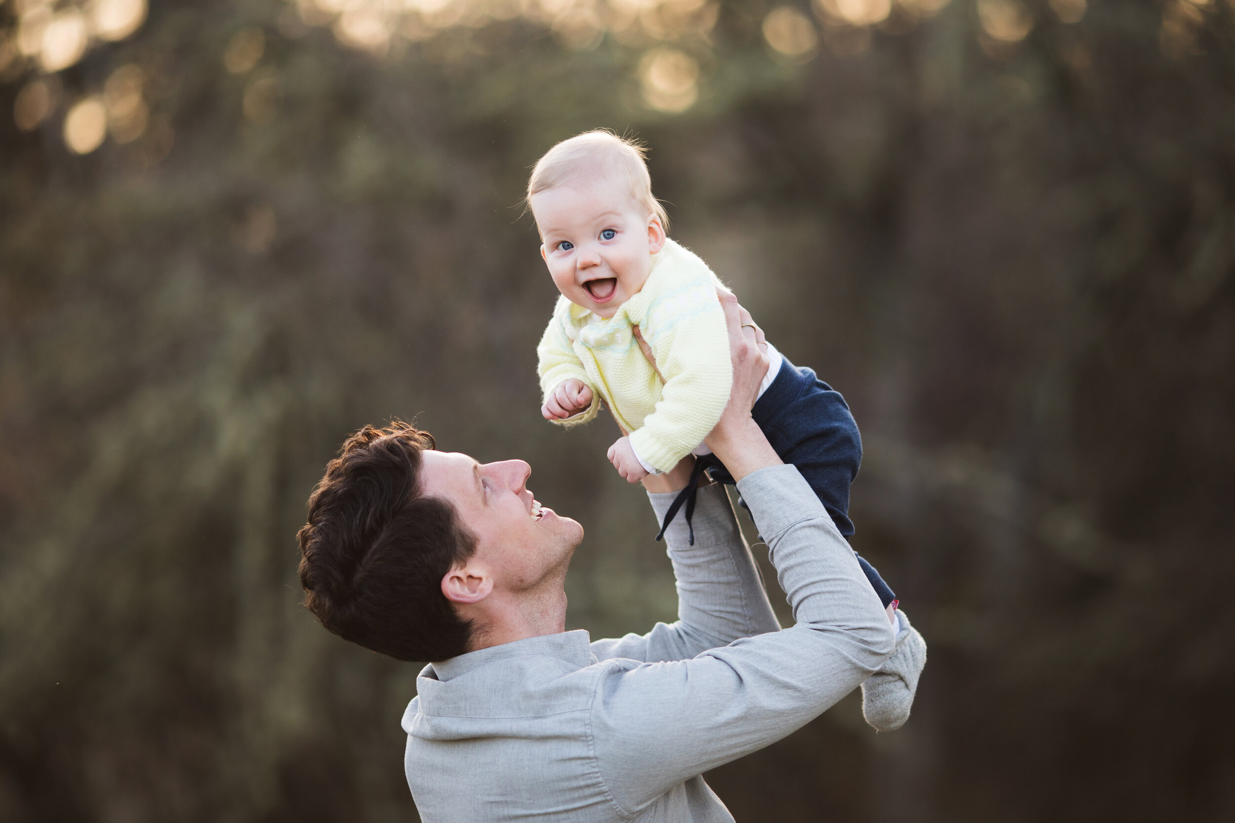 Seattle Father playing with 9 month old son during outdoor photography sessions.