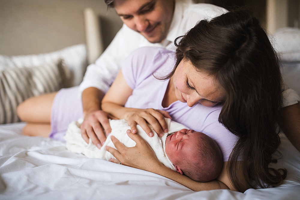 mom and dad comfort newborn baby without newborn photography props