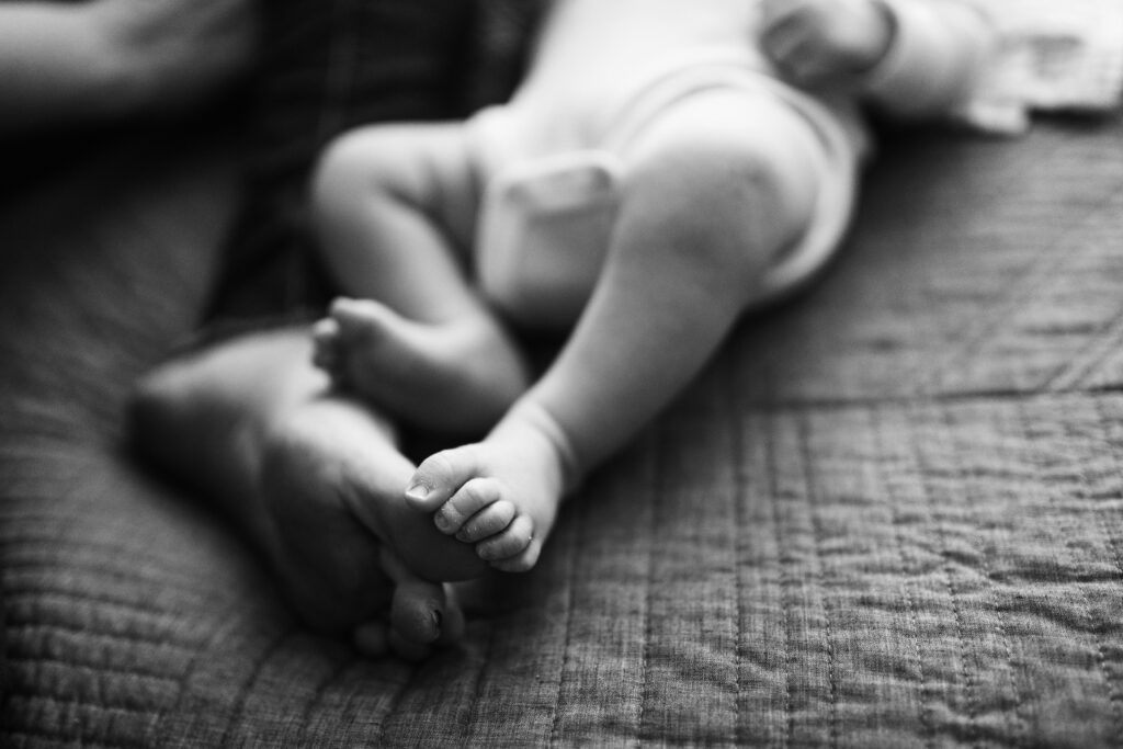 black and white photo of baby and mama toes together during Seattle portrait session